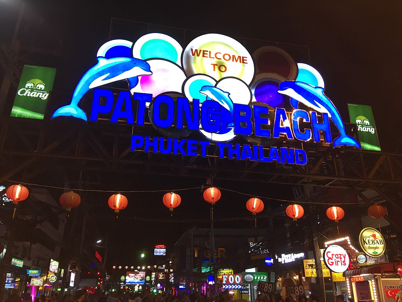 Bangla Walking Street at night — neon signage above the crowd, bars on both sides of the pedestrianised strip.