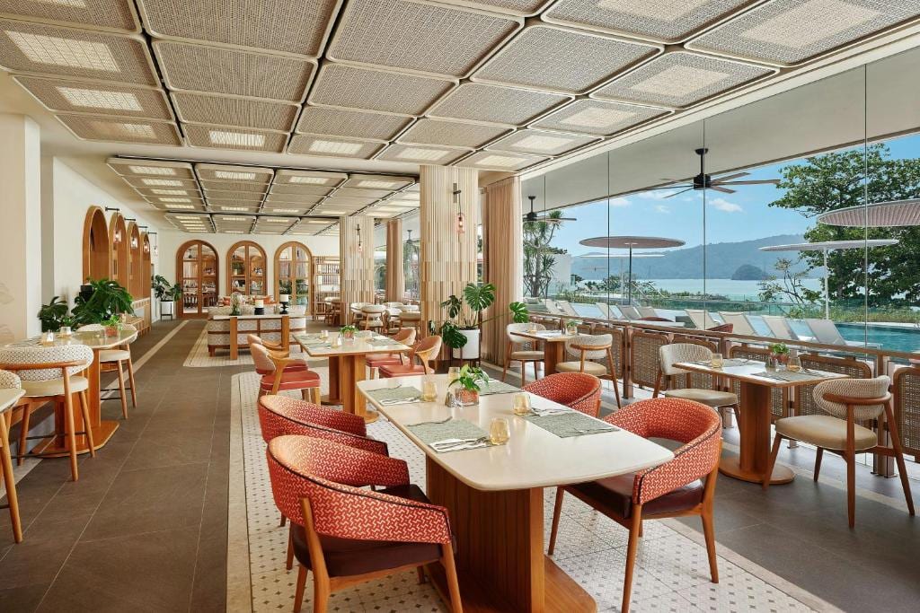 Veranda Resort restaurant interior dining room — woven ceiling, arched walls, sea-facing windows
