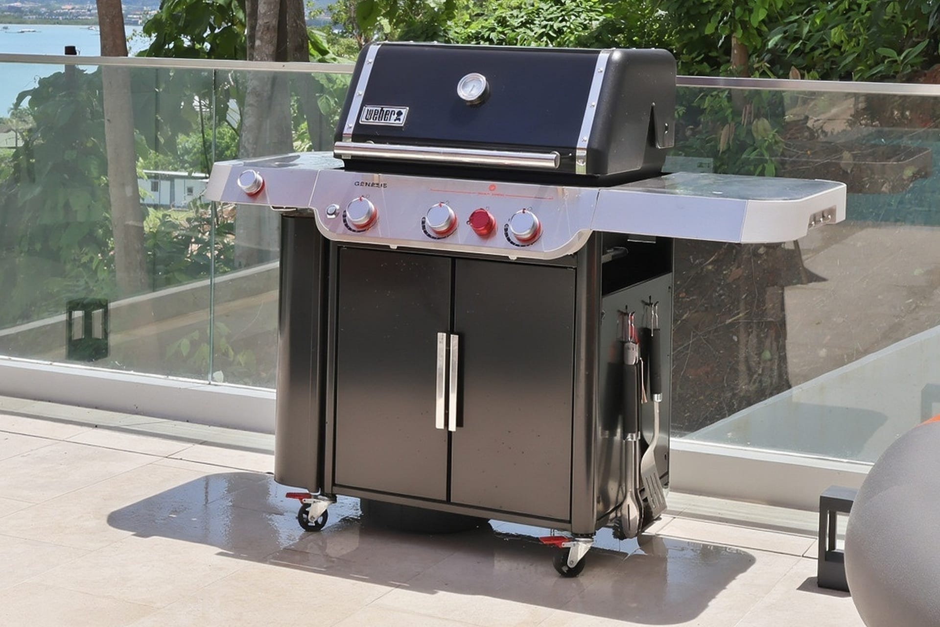 A Weber gas grill on the pool terrace, ready for outdoor cooking