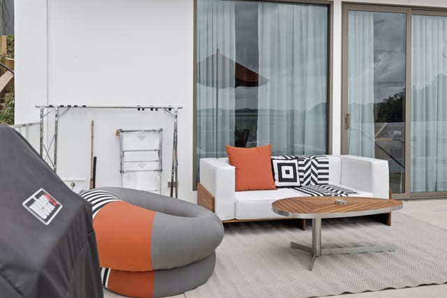 Pool terrace with Weber Genesis E-335 grill, Kenkoon teak sun loungers, and infinity edge